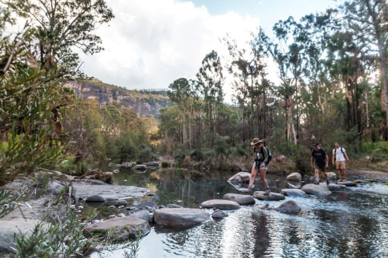 tourists crossing creek