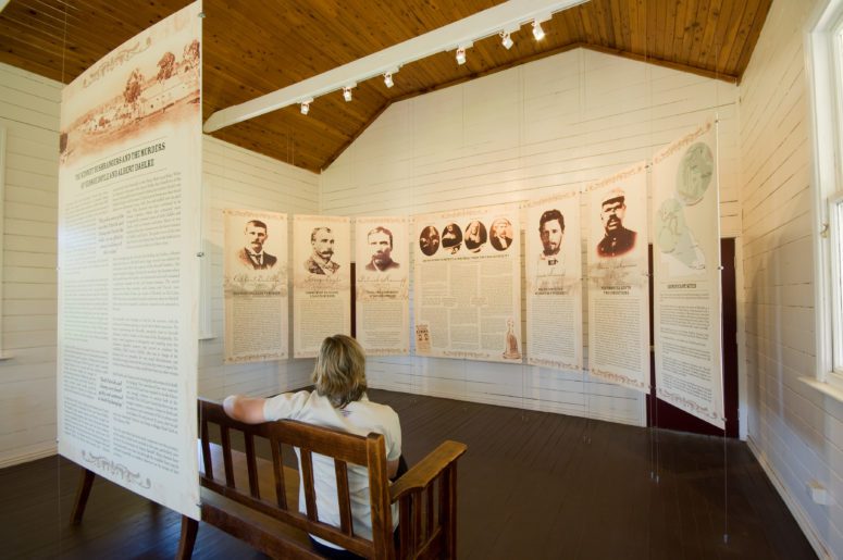 woman sitting while looking at exhibit at exhibit at kenniff court house